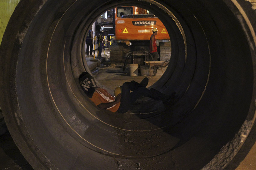 After a day's work, this worker grabs the opportunity to take a nap after having his dinner inside a huge culvert along Anda Street, Davao City. (Ace R. Morandante/davaotoday.com)