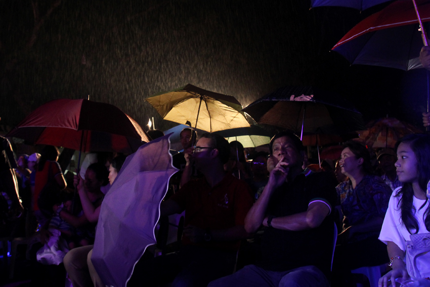 Presidential aspirant Davao City Mayor Rodrigo Duterte and his running mate, Senator Alan Peter Cayetano, attend the opening of the 79th Araw ng Davao in the rain on Saturday evening, March 12. (Ace R. Morandante/davaotoday.com)