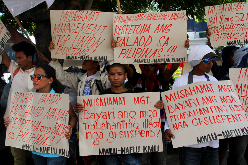 ILLEGAL DISMISSAL. Members of Musahamat Workers Labor Union stage a protest outside the corporate headquarters of Musahamat Farm Inc. in Pryce Tower, Bajada, on Tuesday, March 22. The union condemns the company for firing  52 workers, claiming the move is illegal. (Ace R. Morandante/davaotoday.com)