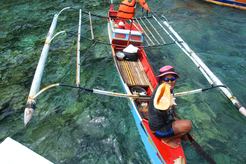 FOR SALE. A sea gypsy sells sea shells for P200 a piece to tourists who are on an island hopping at Talikud Island, Island Garden City of Samal on Saturday, March 12. (Ace R. Morandante/davaotoday.com)