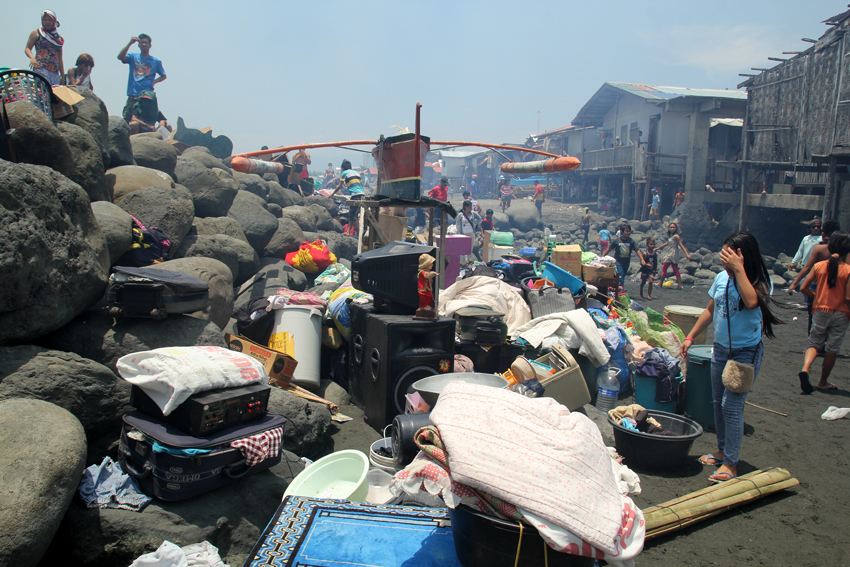 Residents close to the shore have carried their appliances and belongings outside to save it from the fire.