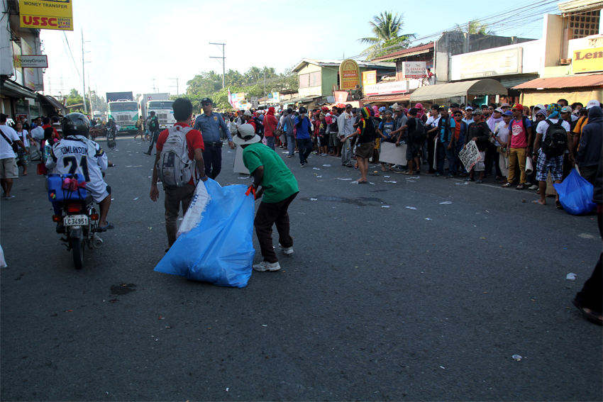 Protesters open the southbound lane and clean the mess in the streets after some of their demands are given.