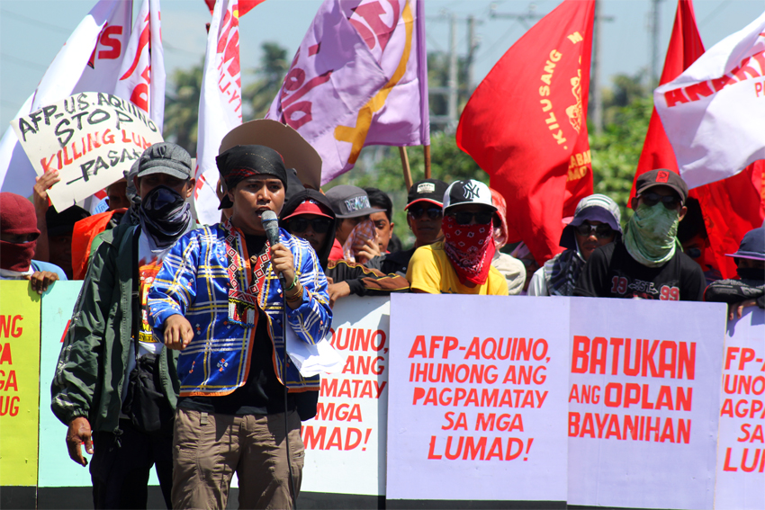 Jong Monzon, spokesman of the PASAKA Luma Confederation of Southern Mindanao explains to local residents why they are in front of the Eastern Mindanao Command headquarters to in Panacan, Davao City.