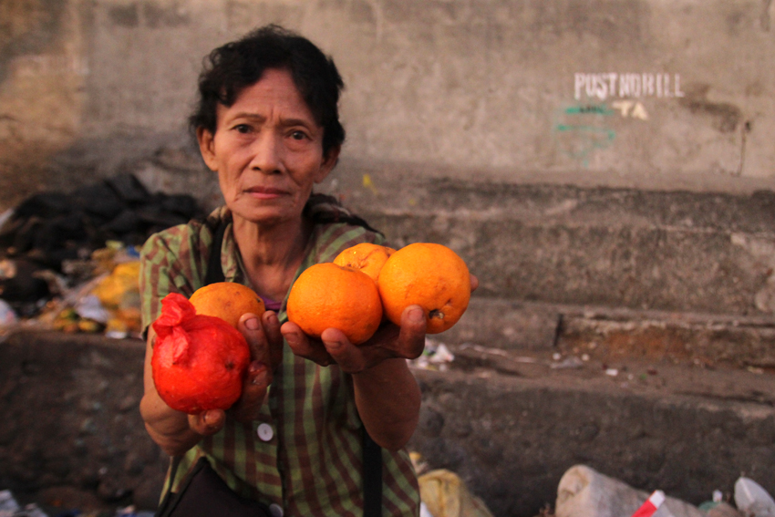 FRUIT SALVAGER. Jolita Ladica, 58, salvages disposed fruits along the streets of Bangkerohan to feed her two sick sons and a step-daughter. (Ace R. Morandante/davaotoday.com)