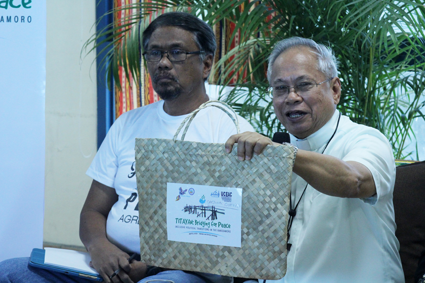 Orlando ​Cardinal ​ Quevedo​,​  archbishop of Cotabato ​City, ​explains  the ​Titayan ​word in the  logo ​as a  Maguindanaon word ​for bridge, as he attends a ​ symposium ​ to bridg​e​  the peace ​process from the current Aquino administration to the next. The symposium is   held at the Ateneo de Davao university, Friday. (Ace R.Morandante/davaotoday.com)