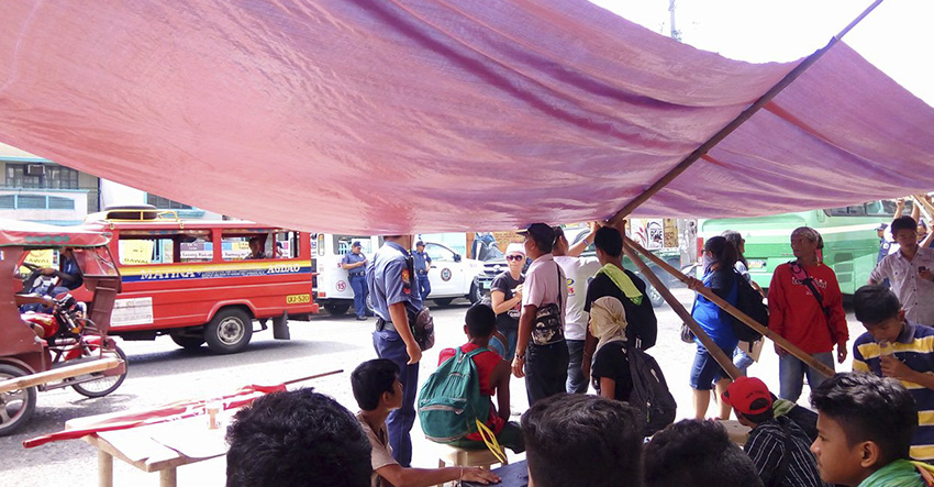 PROTEST. Protesters accede to police officers to remove their tents to prevent traffic congestion in the area. (Earl O. Condeza/davaotoday.com