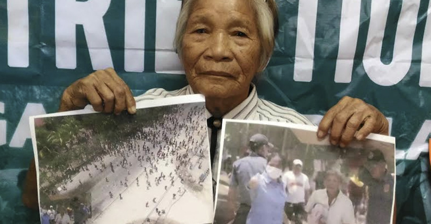 TEMPORARY FREEDOM. Valentina Berden, 78, is among the 78 farmers who were detained after the violent dispersal in Kidapawan City on April 1. The 78 detainees were granted temporary liberty after posting bail with the help of showbiz personalities and lawyers' group. Here she shows the photo of the violent dispersal where she was on the photo being shielded by a police officer. However, Berden was among those who were charged with direct assault against person in authority. (Contributed photo)