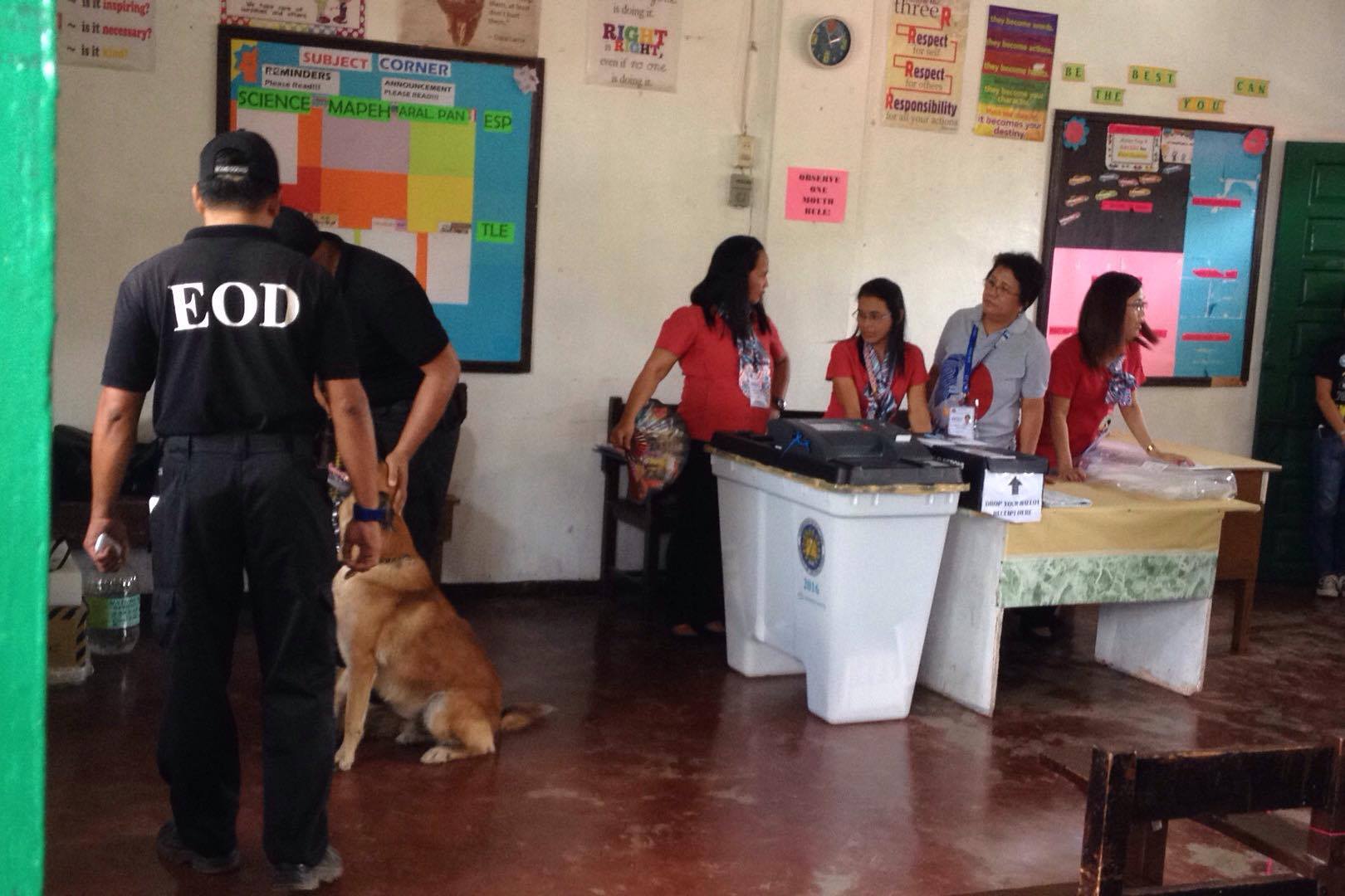 Members of the Explosive Ordinance Division (EOD) inspect Precinct Cluster 416 in Daniel R. Aguinaldo National High School in Matina Aplaya, Davao City where Presidential aspirant Rodrigo Duterte will cash his vote Monday afternoon.(Ace R. Morandante/davaotoday.com)