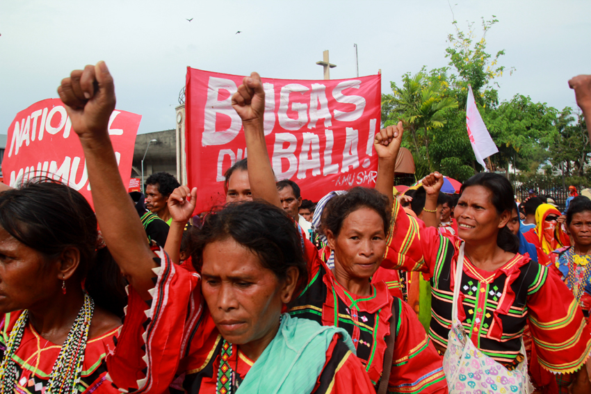 Manobo women raise their fists as they join the workers march in Davao City. They also called for the immediate release of the calamity funds for the El Niño affected area.