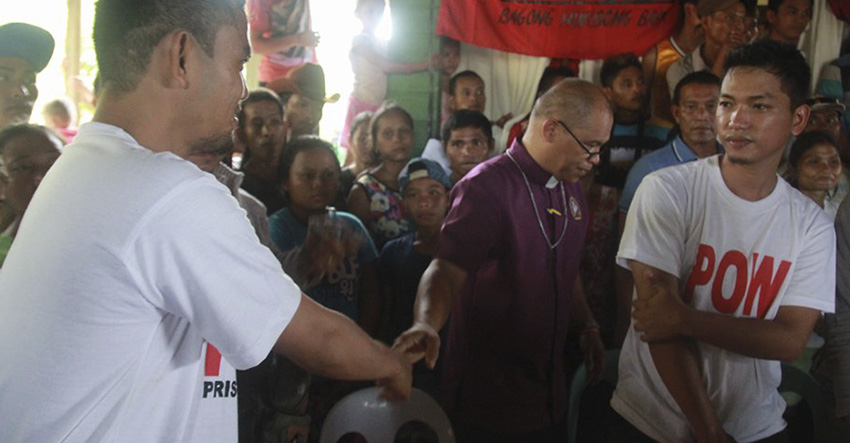 Residents in a village in San Luis, Agusan del Sur witness the New People's Army's release of their prisoners, Army Private First Class Glen Austria and Diven Tawide.