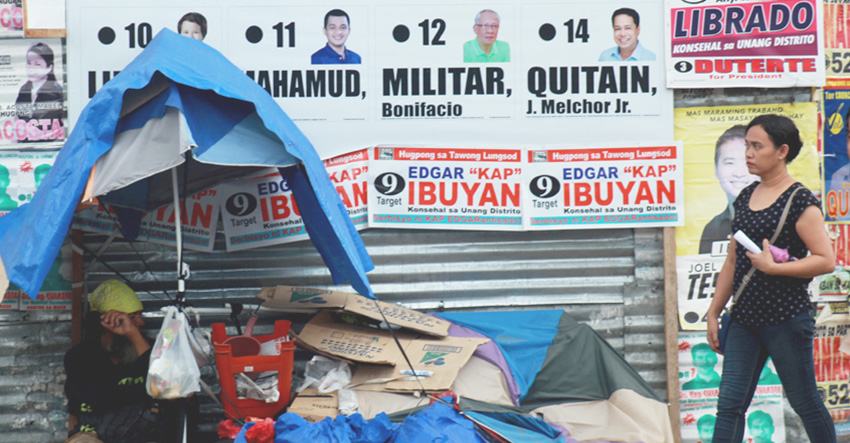 HOMELESS. A beggar puts up his shanty home in a corner along Anda street, Davao City which is covered with huge campaign materials.(Ace R. Morandante/davaotoday.com file photo) 