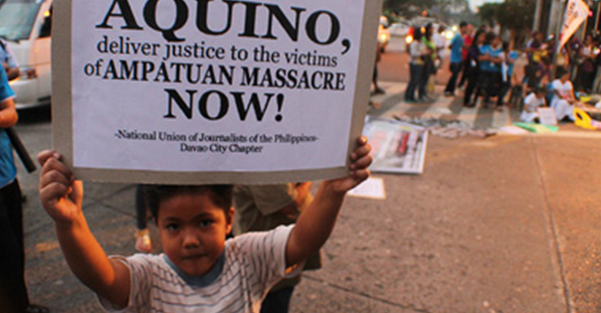 A son of a media practitioner in Davao City holds a placard calling on President Benigno Aquino III to deliver justice to all victims of the Ampatuan massacre during a solidarity protest action held in November 2012. (davaotoday.com file photo by Ace R. Morandante)