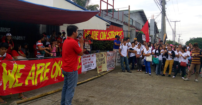 LISTENING. Workers who are still employed, patiently stay outside the company and listen to the protesters who are airing their demands and explaining to the new workers their rights and welfare. (Earl O. Condeza/davaotoday.com)