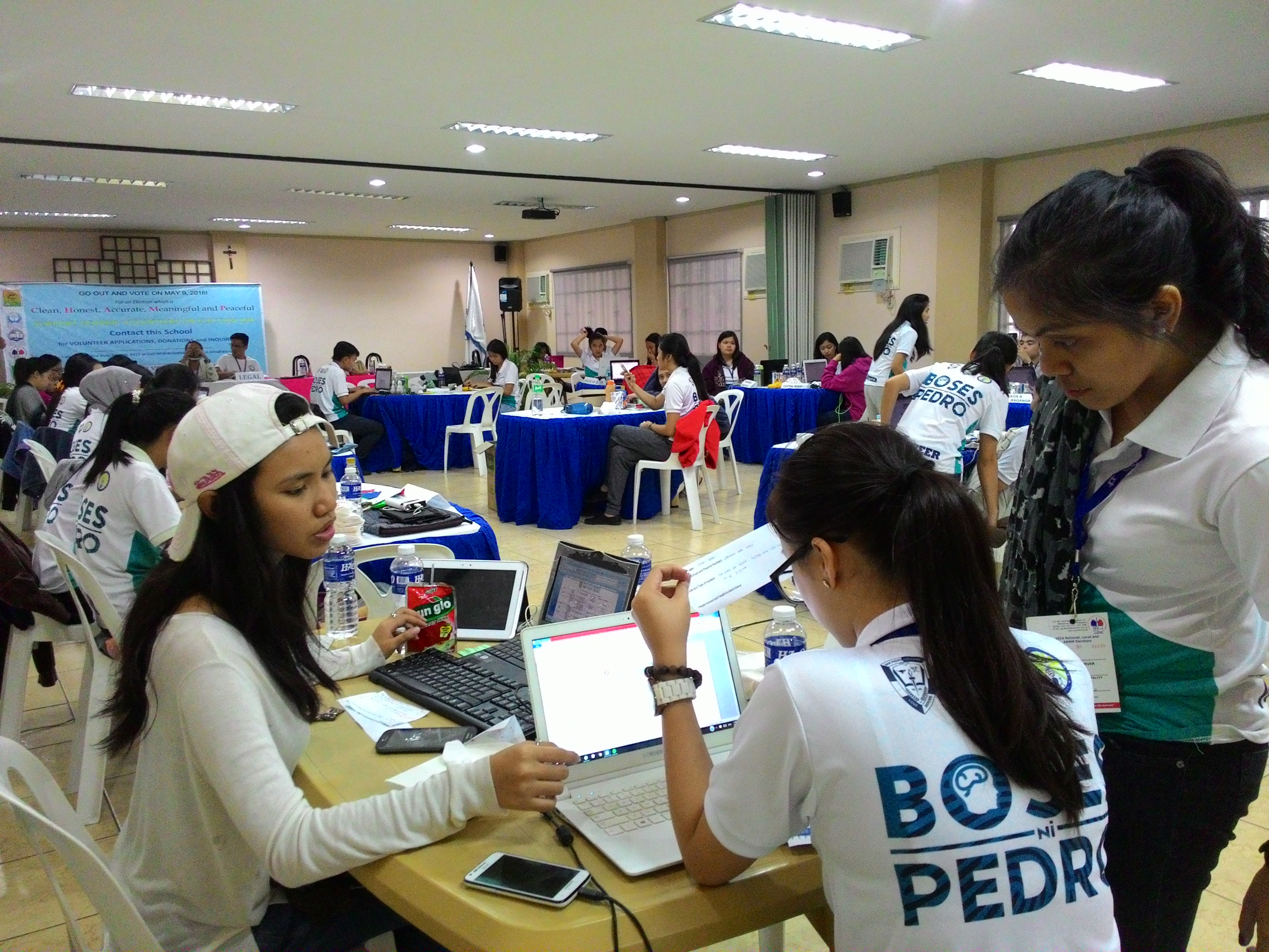 Volunteers of the E-CHAMP respond to voters' complaints, at their command center, located at the Davao Association of Catholic Schools Building in Davao City.(May Anne Love Deseo/davaotoday.com)