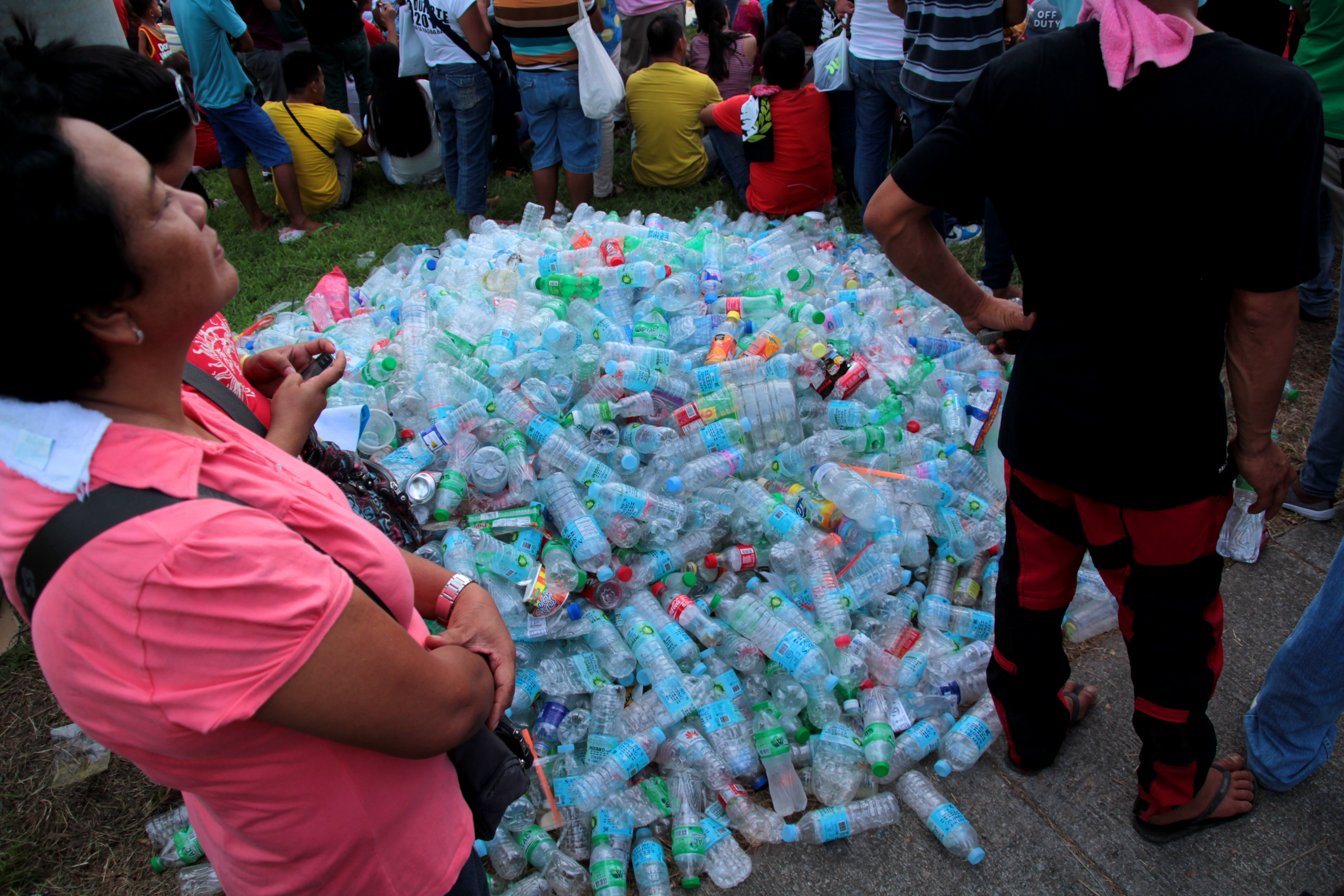 RECYCLABLE. Party-goers throw empty water bottles in one place to make it easy for garbage segregation. 