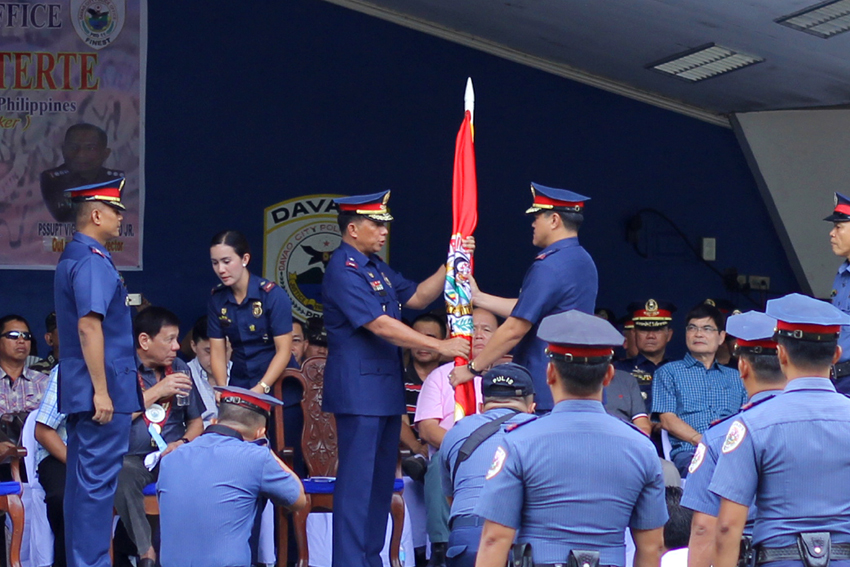 TURNOVER CEREMONY. Police Chief Superintendent. Manuel Gaerlan, acting regional director of the Police Regional Office 11 turns over the PNP flag to Senior Supt. Michael John Dubria as the new Davao City Police Office director during the ceremony held at the Davao City Police Office grounds on Friday, June 24, 2016.(Ace R.Morandante/davaotoday.com)