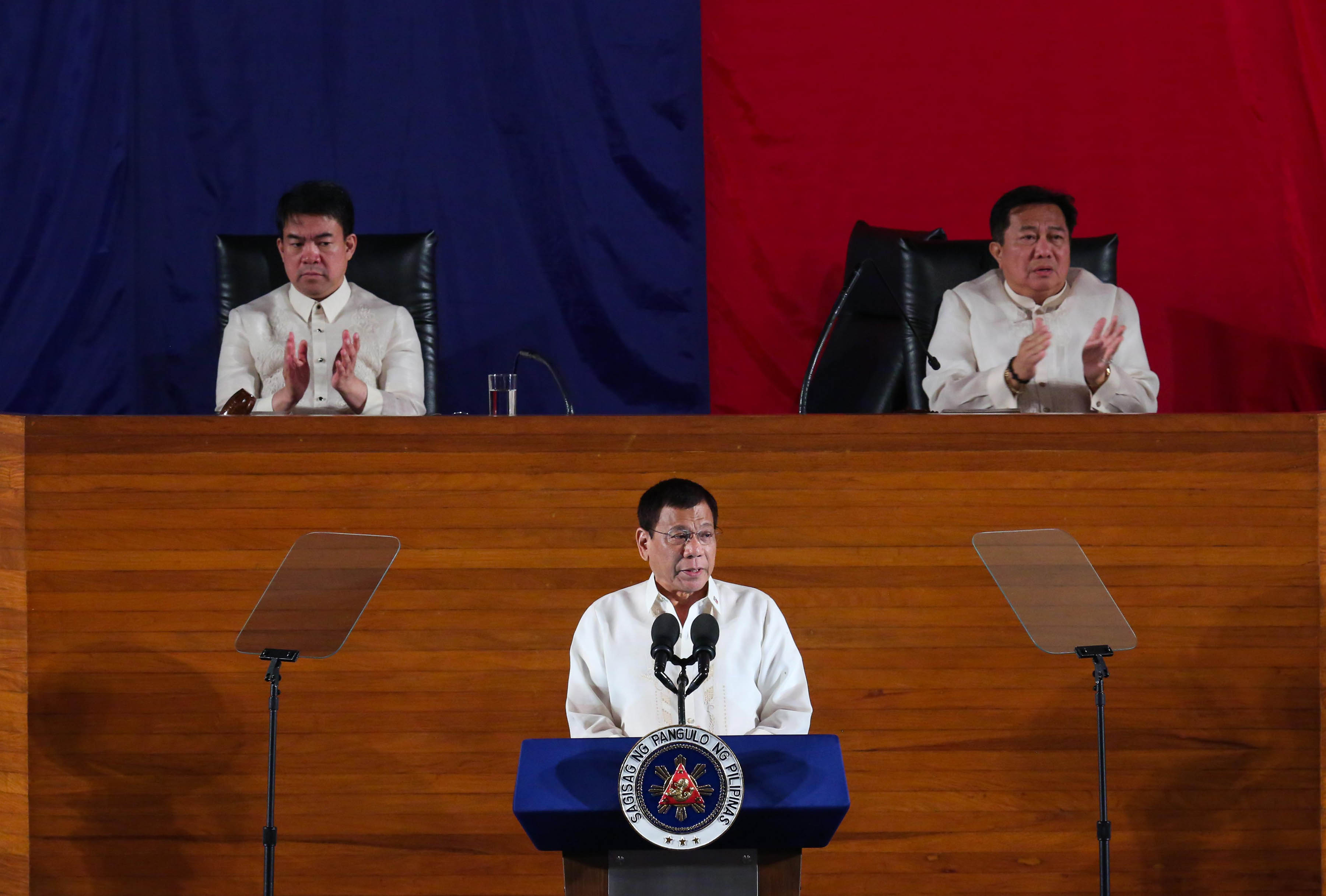 Senate President Aquilino 'Koko' Pimentel III (left) and House Speaker Pantaleon Alvarez applaud as President Rodrigo R. Duterte announces during his first State of the Nation Address at the Batasang Pambansa in Quezon City on Monday, July 25, 2016 that he will lower the income tax. The three leaders are all from Mindanao. (ACE MORANDANTE/PPD)