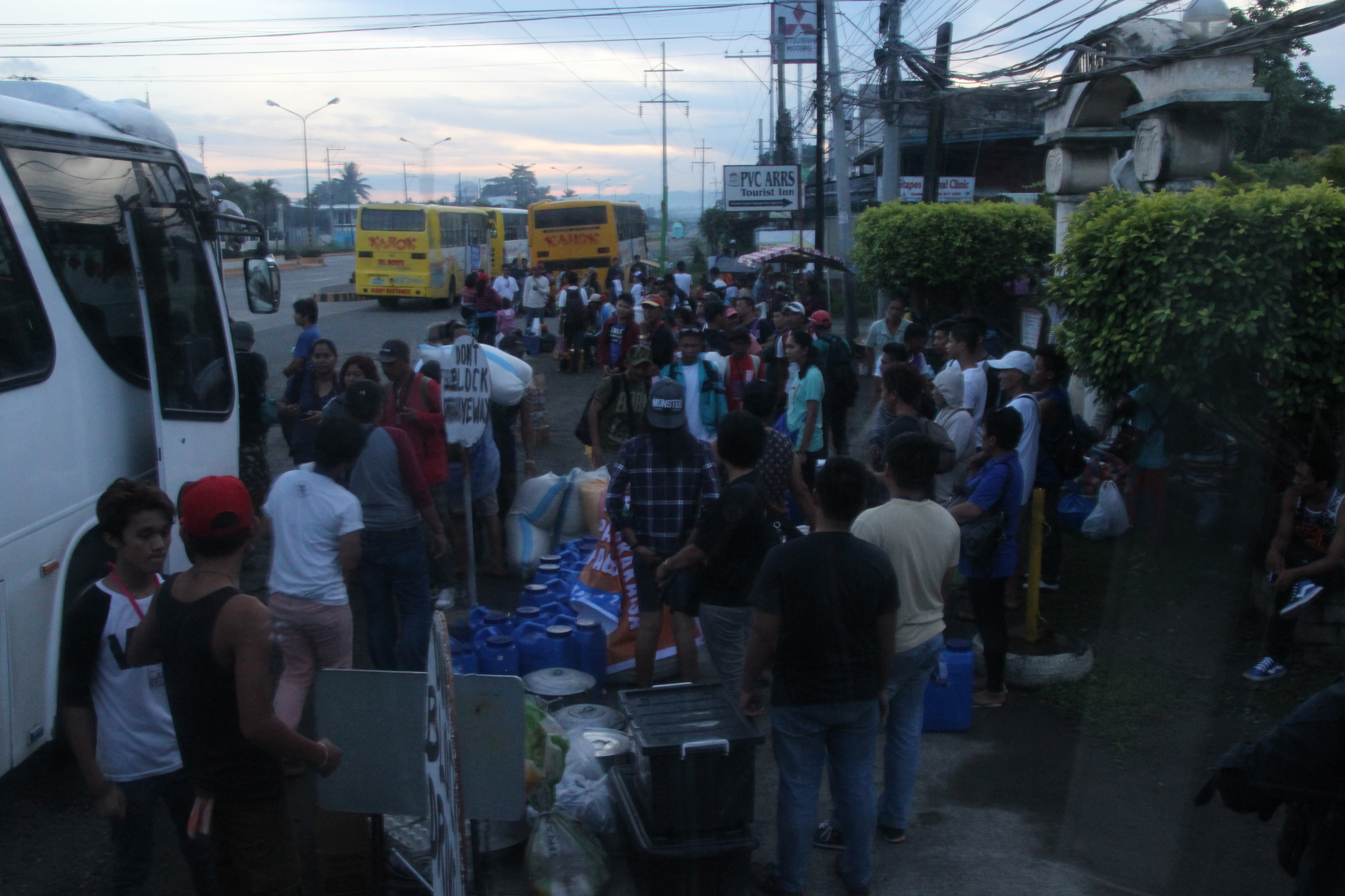 Delegates of the Manilakbayan for SONA line up to board the buses along the national highway in Tagum City on Tuesday morning.