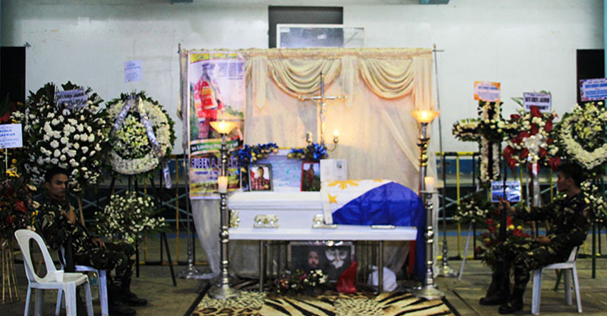 GUARDS. Two soldiers sit on both sides of the slain tribal leader, Ruben Labawan's coffin in the latter's last day of wake on Thursday, July 14.  (Paulo C. Rizal/davaotoday.com)