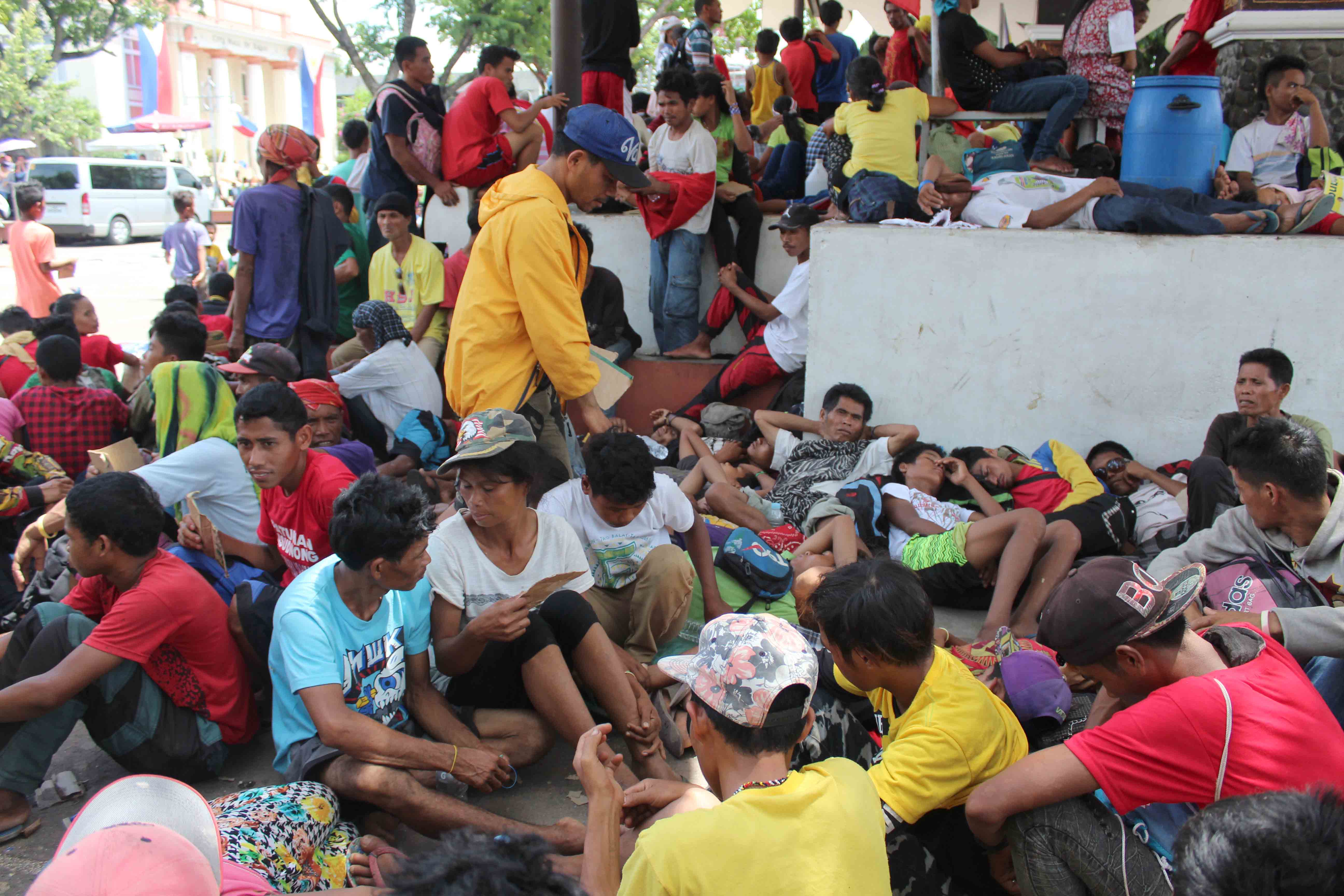 While waiting for President Rodrigo Duterte's inaugural speech, farmers and Lumad people rest in Rizal Park, just beside the City Hall of Davao. Duterte took his oath at 12:00 noon on Thursday, June 30.