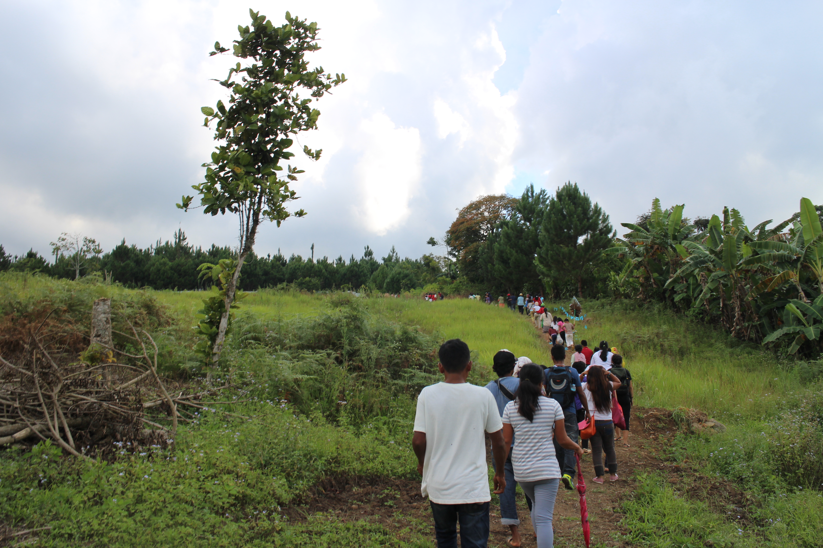 Mourners walk towards the cemetery in Sitio Kahusayan in Barangay Manuel Guianga, Tugbok district in Davao Ciy where Lumad leader Herme Alegre will be buried. A portion of the land with galvanized iron and pine trees is the former ancestral domain of the Klata tribe in the area which is now owned by a religious sect. 