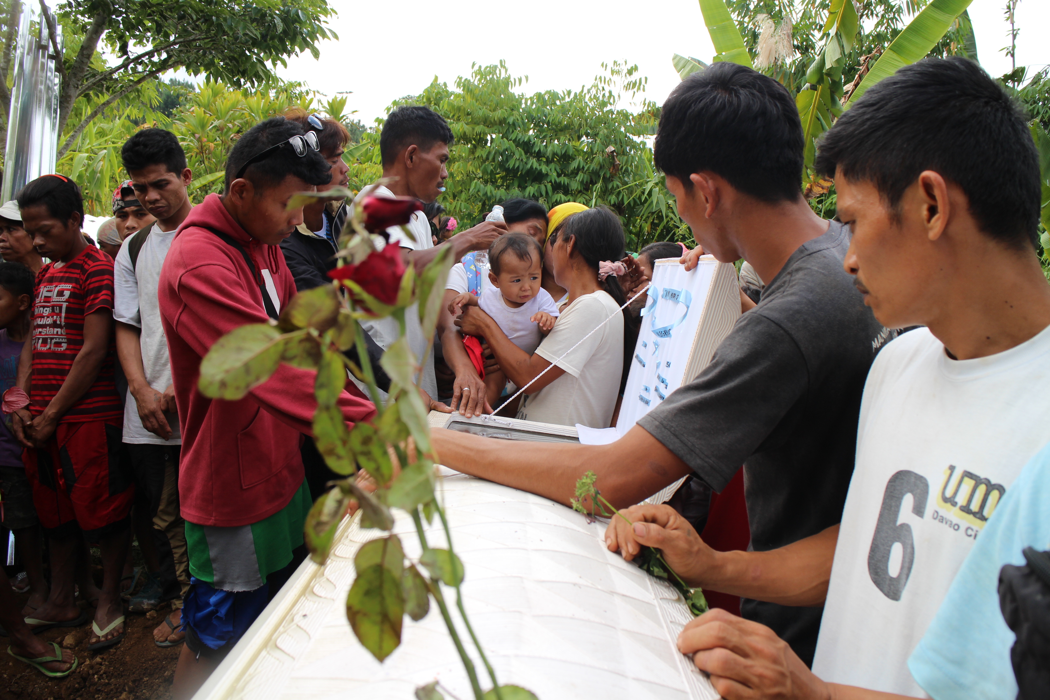 Relatives and friends of Herme Alegre pay their last respect before he is buried in Sitio Kahusayan, Barangay Manuel Guianga, Tugbok district in Davao City on Sunday, July 24.