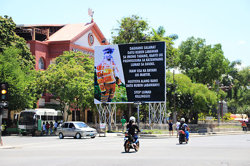 A billboard in front of the Sangguniang Pambansa in San Pedro Street, Davao City declares slain tribal chieftain Ruben Labawan a hero and a martyr. In a statement, the New People's Army owned up to the killing, saying that Labawan was "guilty of blood debts and thereby meted with the death penalty for serious crimes against the people." Paulo C. Rizal/davaotoday.com)