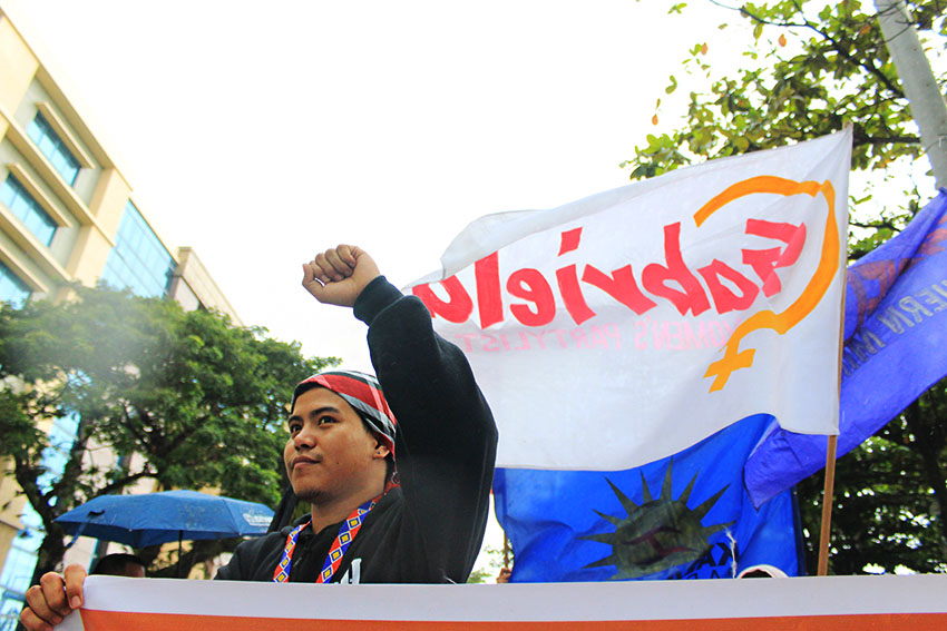 Jong Monzon, secretary general of the Pasaka Confederation of Lumad Organizations, marches along with other sectors during the 'People's SONA' on Monday, July 25. (Paulo C. Rizal/davaotoday.com)