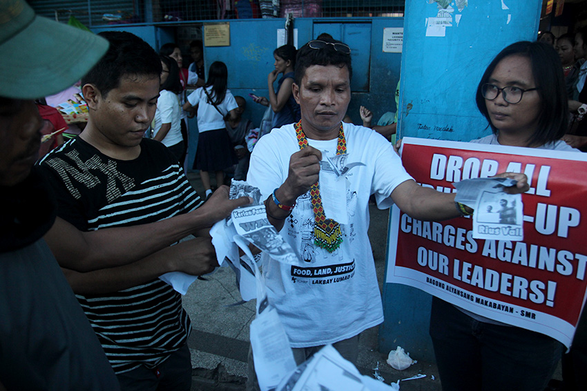 REMOVED. Activists tear down wanted posters of their leaders along San Pedro Street, Davao City during a protest rally on Monday, July 4. (Earl O. Condeza/davaotoday.com)