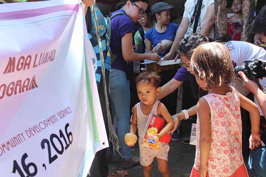 Students of the University of the Immaculate Conception (UIC), Davao City interacts with the Lumad students of the MISFI Academy students as they distribute school supplies at the United Church of Christ in the Philippines Haran compound in Father Selga Street on Saturday afternoon, July 16. (Medel V. Hernani/davaotoday.com)