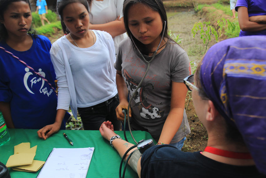 Despite lacking in school facilities, students studying in MISFI School are taught not only to read and write, but also to administer basic health services.Here, a student determines the blood pressure of one of the delegates of the International Solidarity Mission in Barangay Kisante, Makilala, North Cotabato. (Paulo C. Rizal/davaotoday.com)