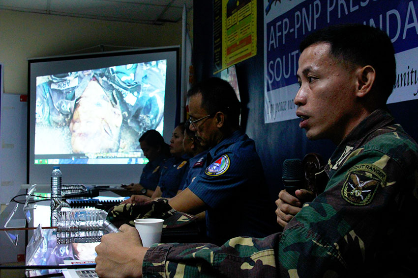 EXPLICIT. Army spokesperson Capt. Rhyan Batchar shows the photos of the alleged mutilated corpses of Corporal Jimmy M. Bayta, Corporal Gilmar C. Mapa, and Private First Class Rolen Roy C. Sarmiento, three of the four soldiers who died in a series of offensives conducted by the New People's Army in Monkayo, Compostela Valley last week. (Paulo C. Rizal/davaotoday.com)