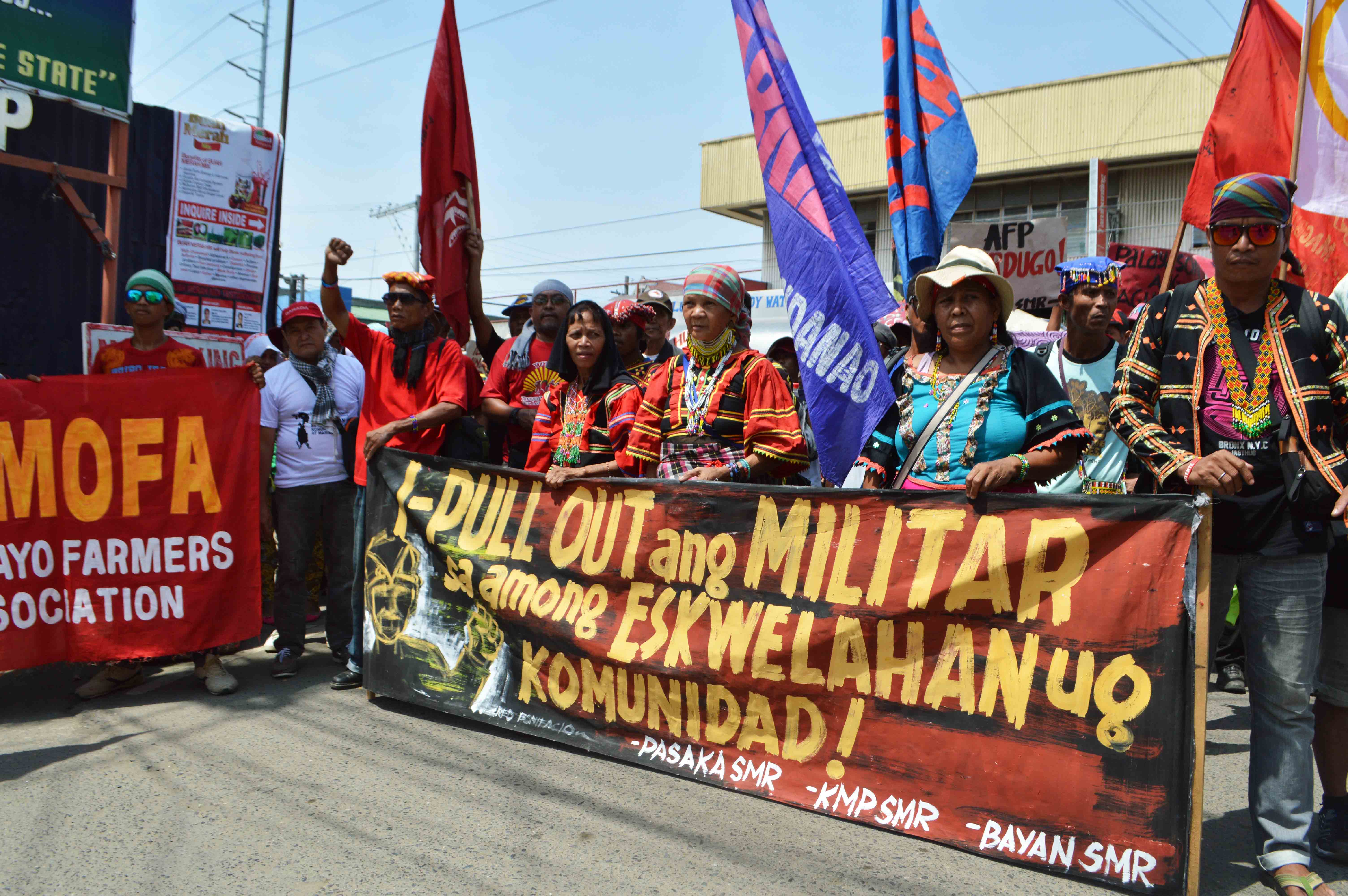 Protesters called for the pullout of military troops in communities during a rally held outside the headquarters of the Eastern Mindanao Command.