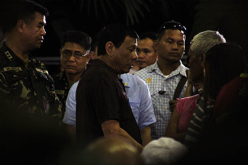 IN CONSOLATION. President Rodrigo Duterte consoles the family members of the four soldiers who were ambushed by the 8th Pulang Bagani Company of the New People's Army in Monkayo Town, Compostela Valley, Friday morning, August 5. Duterte attended the soldiers' wake at the Naval Station Felix Apolinario in Panacan, Davao City around 1:00 am on Sunday, August 7, 2016. (Paulo C. Rizal/davaotoday.com)