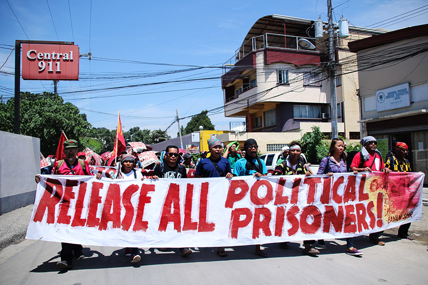 Farmers and Lumad march from the  the National Commission for Indigenous Peoples Region XI office to the Benigno S. Aquino Hall of Justice in Ecoland, here to call for the release of political prisoners and the dismissal of "trumped up" charges against them on Wednesday morning, August 24. (Paulo C. Rizal/davaotoday.com)