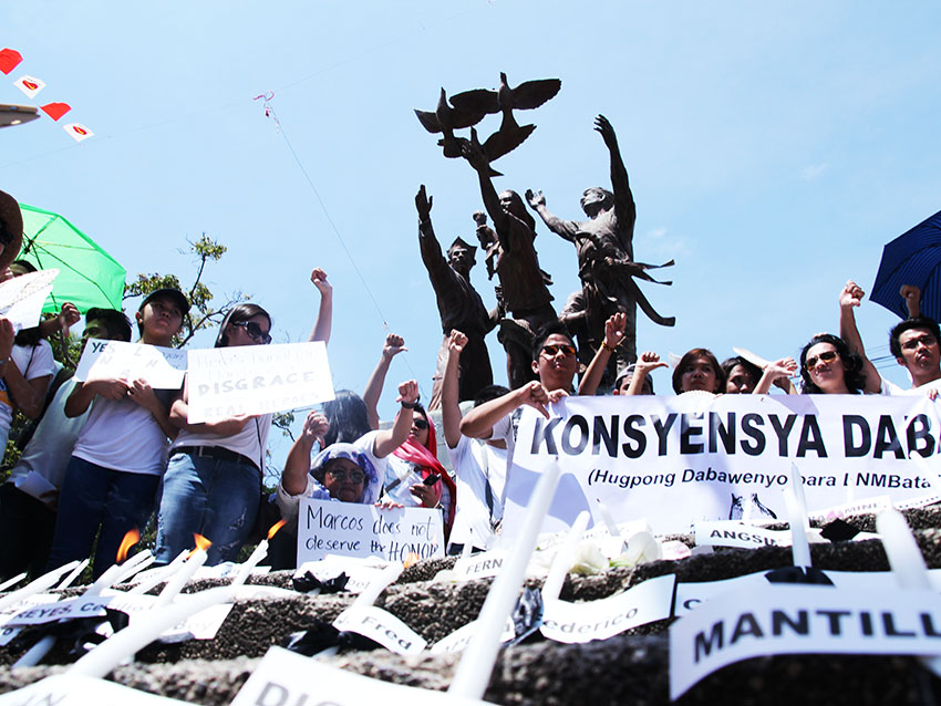 Members of the group Konsensya Dabaw troop in front of San Pedro Church in Davao City on Sunday morning, August 14  to call on President Duterte to bury former president Ferdinand Marcos, Sr. in Batac, Ilocos Norte, not in the Libingan ng mga Bayani. On the candles are the names of Davaoeños who became  victims of Martial Law that was proclaimed by the late strongman.(Paulo C.Rizal/davaotoday.com)