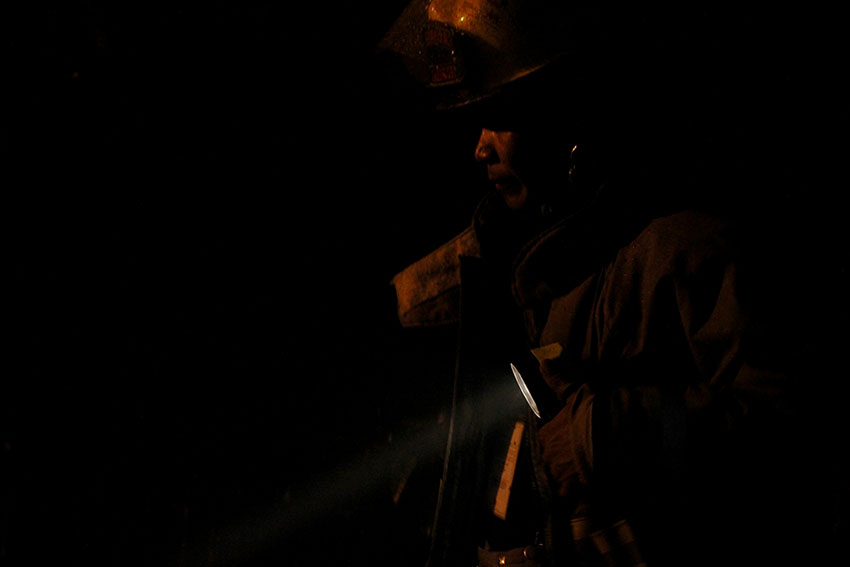 FIREMAN. A fireman uses his flashlight to inspect a burned house in Pag-asa Village, Matina Aplaya, Davao City on Wednesday afternoon, August 10, 2016.  Five houses were razed in the fire. (Paulo C. Rizal/davaotoday.com)