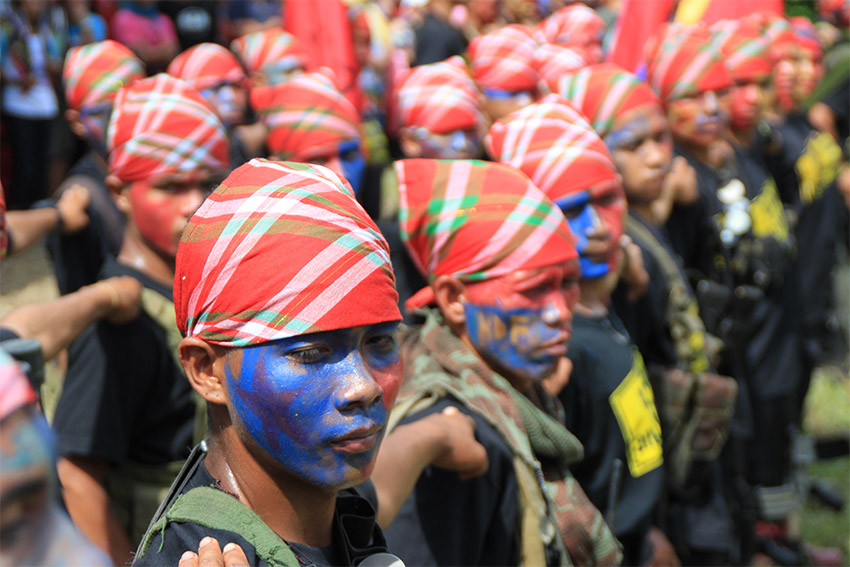 Guerrilla fighters of the New People's Army prepare their formation at the start of the ceremony for the release of its two captive police officers in a village in Lupon, Davao Oriental on Friday, August 26, 2016. (Earl O. Condeza/davaotoday.com file photo)