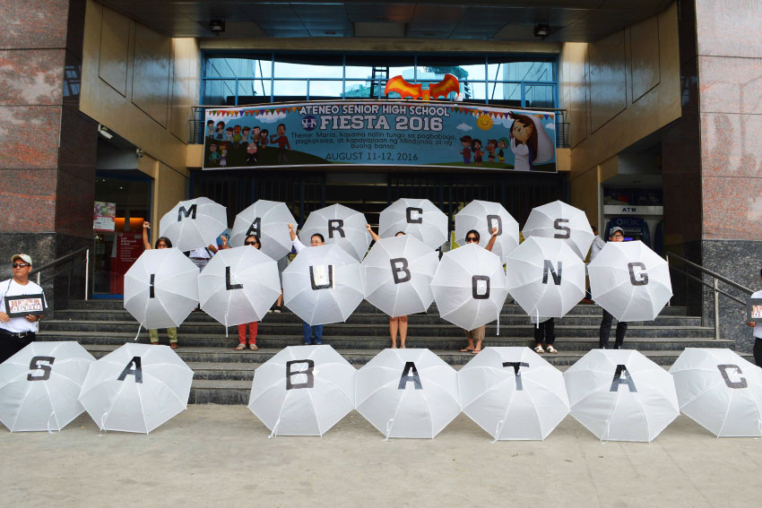 Using umbrellas, members of Konsyensya Dabaw movement renew their call to President Rodrigo Duterte to have the burial of the late strongman, President Ferdinand Marcos, Sr., in Batac, Ilocos Norte and not at the Libingan ng mga Bayani. The group held their protest action in front of the Ateneo de Davao University on Sunday, August 21, 2016. (Medel V. Hernani/davaotoday.com)