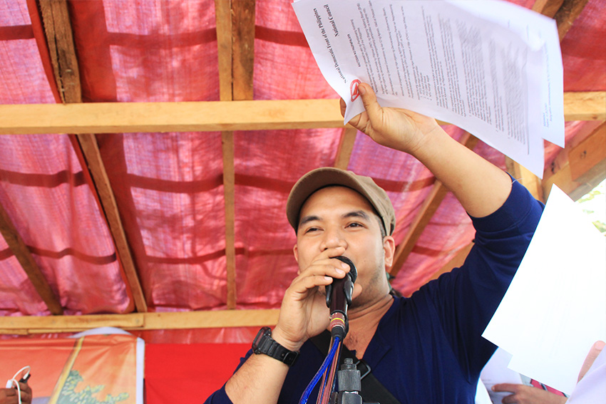 Ka Edroy, political officer of the NPA's Front 16 presented the signed papers to the crowd.
