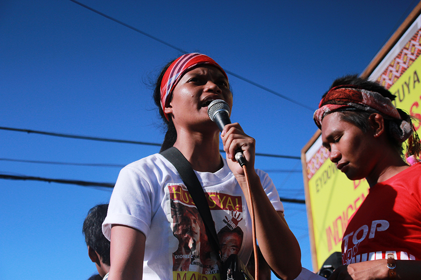 Michelle Campos, daughter of slain Lumad leader Dionel Campos, leads hundreds of Lumad evacuees inside the provincial sports center in Tandag City during the commemoration of the one year anniversary of the killing of Lumad leaders in Barangay Diatagon, Lianga town, Surigao del Sur province on Thursday afternoon, September 1. (Paulo C. Rizal/davaotoday.com)