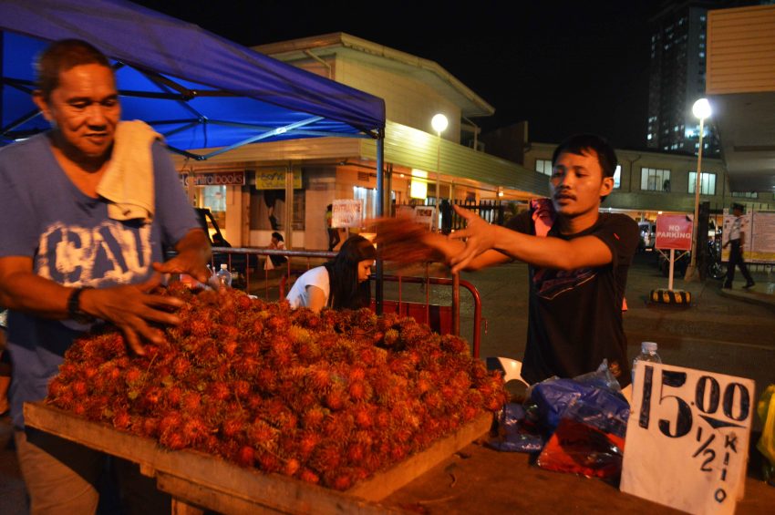 Fruit venders display Rambutan on top of a table bearing a price tag P15 for a 1/2-kilo.  (Medel V. Hernani/davaotoday.com)