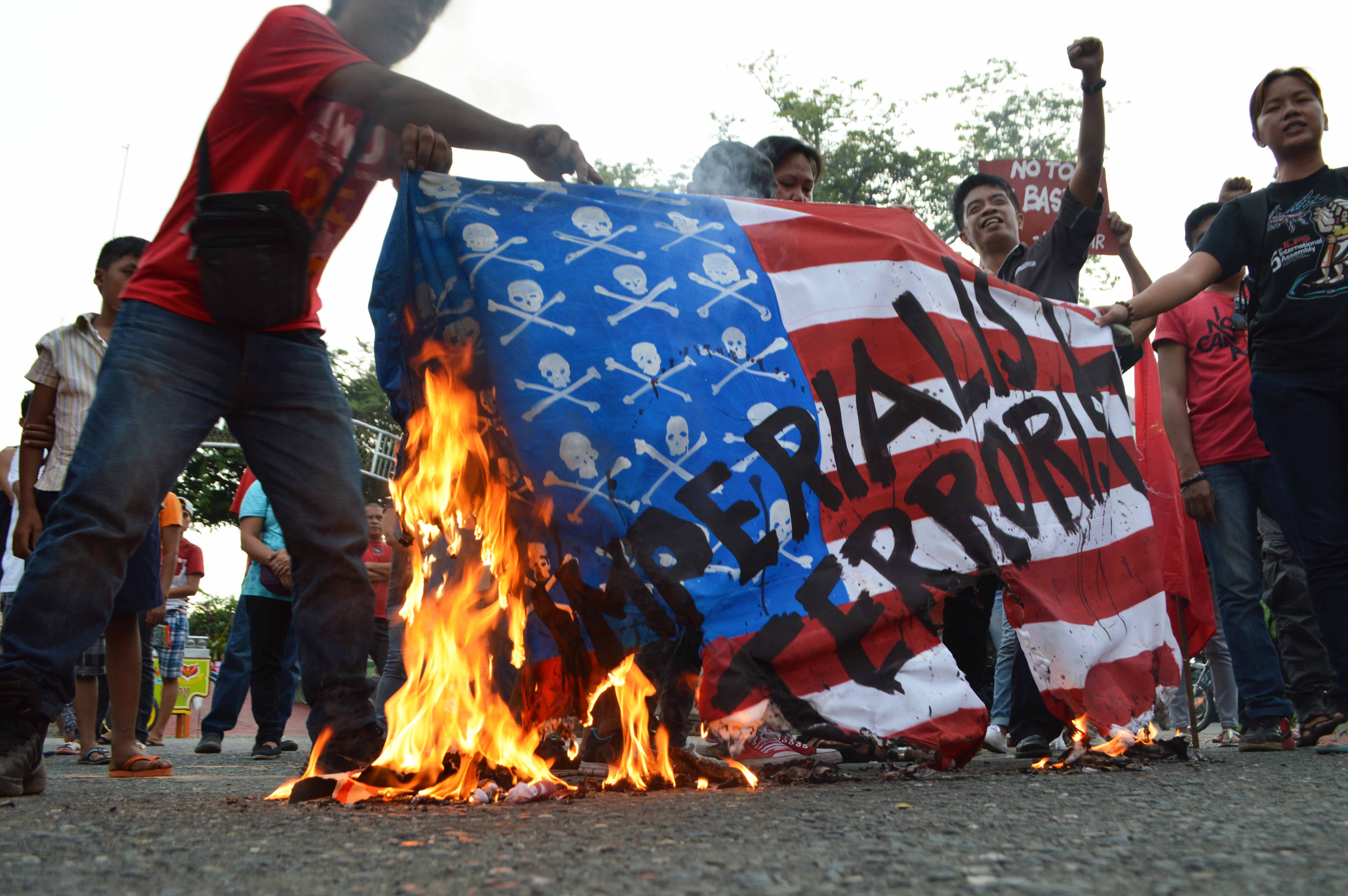 Davao City protesters burn a US flag to.protest its war on terror.