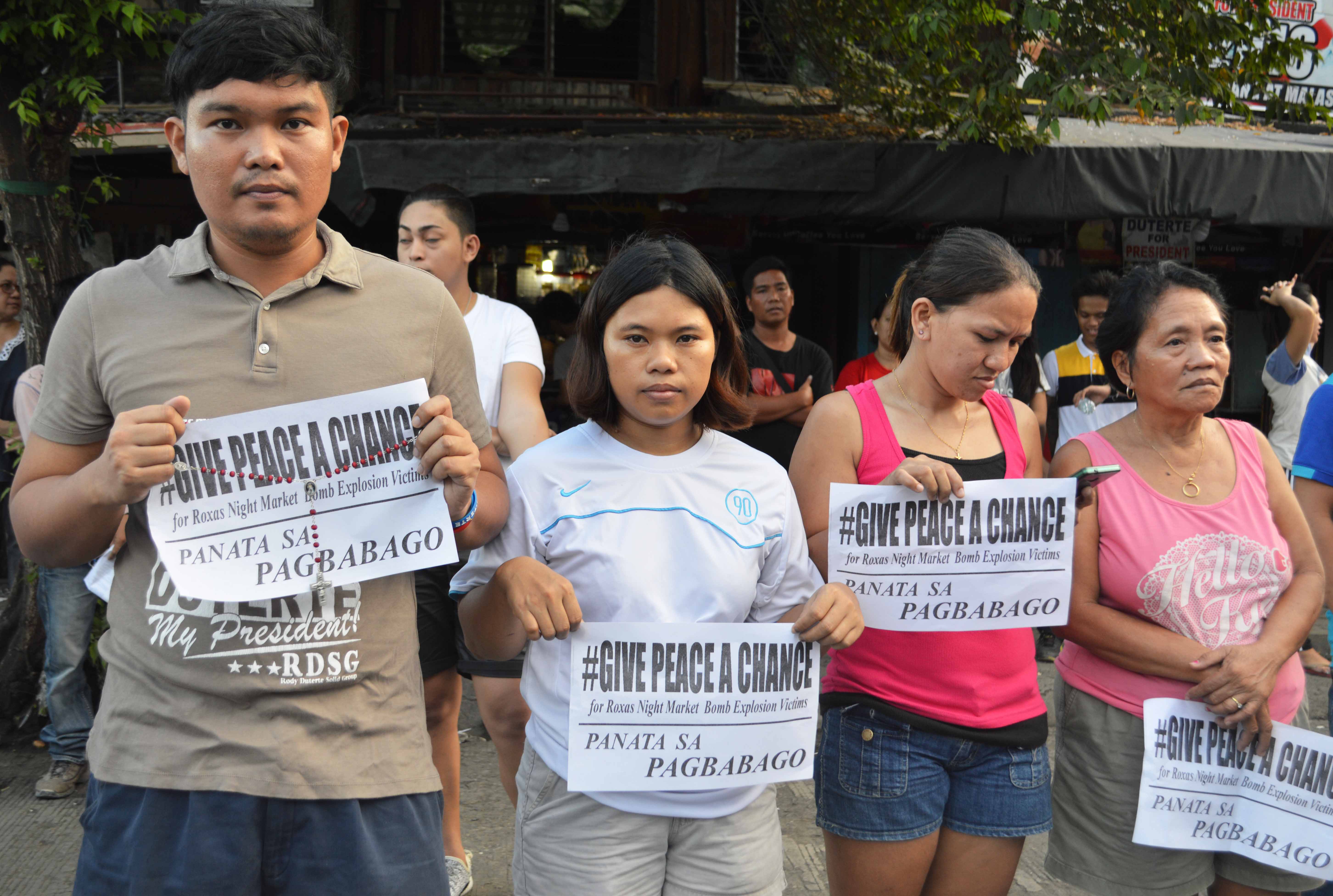 People in neighboring barangays near the blast site join the mass for the victims in Roxas Avenue, Davao City. They asked to give peace a chance.