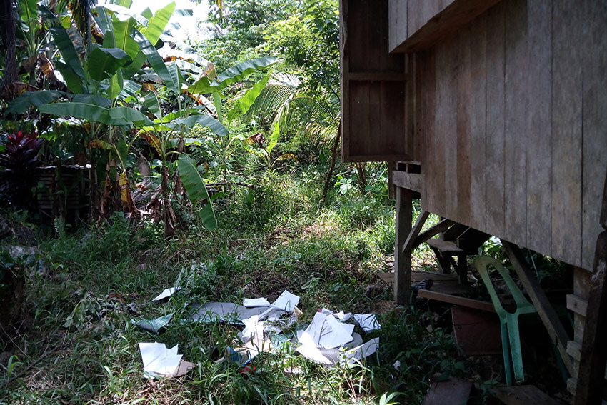 SCATTERED. Papers, clothes, and other things are found scattered inside the house of the slain community leader Dionel Campos. (Earl O. Condeza/davaotoday.com)