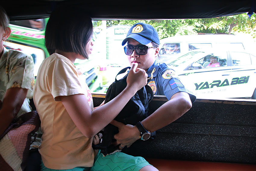A policewoman inspects bags of jeepney passengers along R. Castillo street, Davao City. Routine inspections of both public and private vehicles have become the norm in the city after the Davao bombing that claimed at least 14 lives and wounded 70 others on September 2. The incident led President Rodrigo Duterte's to issue a proclamation declaring a state of national emergency. (Paulo C. Rizal/davaotoday.com)