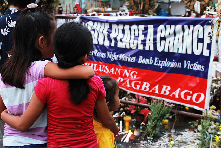 DAVAO BOMBING MEMORIAL. Everyday since the Davao bombing incident that claimed the lives of 15 and wounded 69 others, people from all over the city visit blast site along Roxas Avenue at different times of the day to light candles and offer flowers and prayers. (Paulo C. Rizal/davaotoday.com)