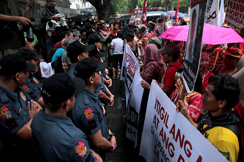 A police stands outside the gates of the Department of Justice's main office in Padre Faura Street in Manila as Lumad and Moro activists held a protest rally on Monday to call for justice for all the victims of human rights violations and the dismissal of "trumped-up" charges filed against the militant leaders and members. (Paulo C. Rizal/davaotoday.com)