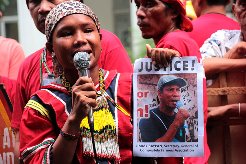 An emotional Christina Lantaw holds a picture of slain farmer and anti-mining advocate Jimmy Saypan during Monday’s protest rally led by national minority alliance group Sandugo in front of the Department of Justice office in Padre Faura Street, Manila. (Paulo C. Rizal/davaotoday.com)