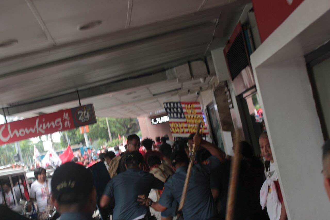 Police runs after protesters retreating towards T.M. Kalaw street after a rally in front of the US Embassy in Manila Wednesday morning. (Paulo C. Rizal/davaotoday.com)